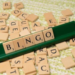 Wooden Scrabble tiles arranged to spell 'BINGO' on a green rack.